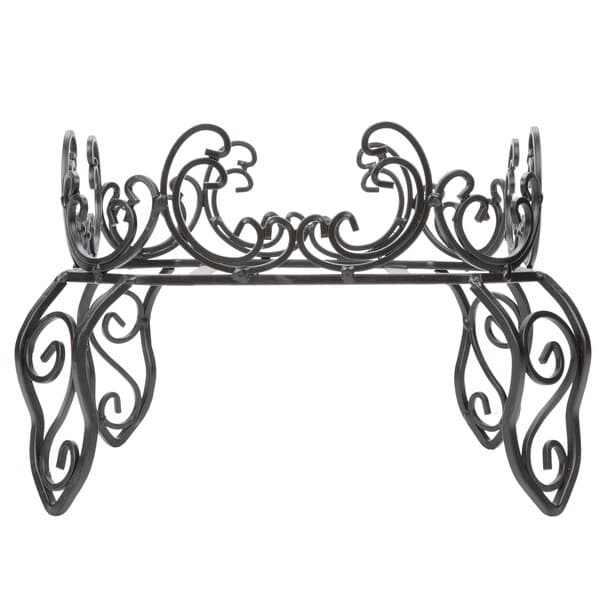 A black metal stand with swirls holding an Acopa 5 gallon glass beverage dispenser.