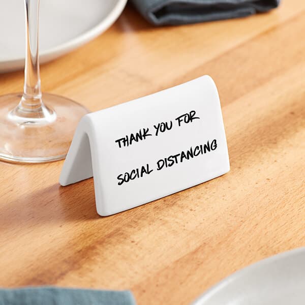 An Acopa double-sided white ceramic table tent with black text.