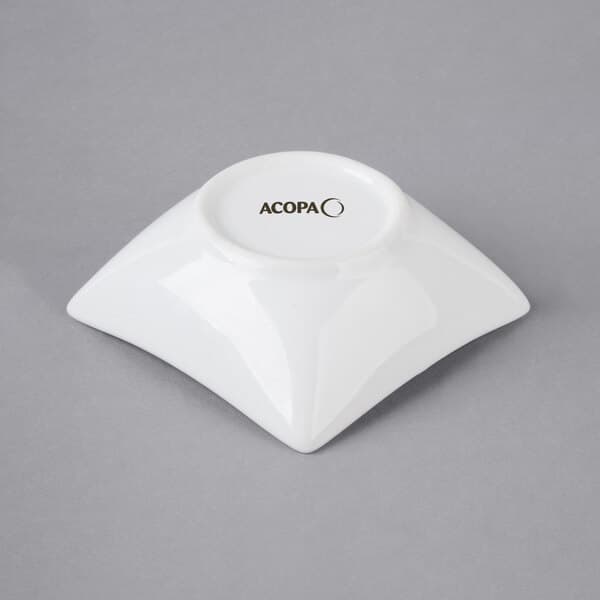 A white square Acopa porcelain sauce cup.
