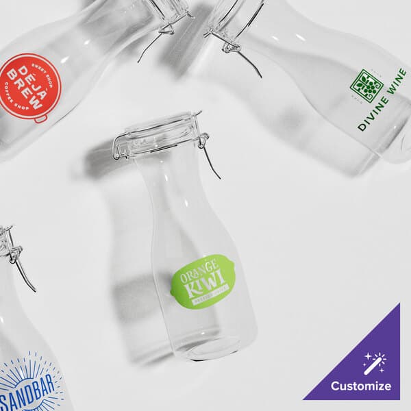 A group of Acopa clear glass carafes with metal clamps.