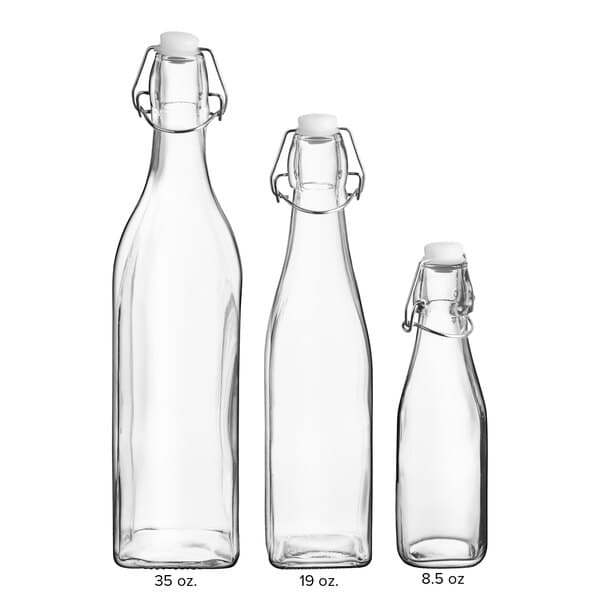 A group of three clear glass Acopa bottles with wire bail swing top lids and handles.