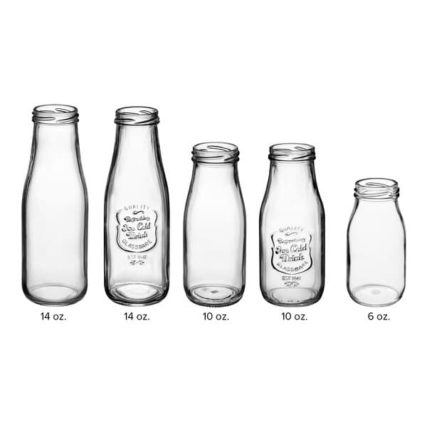 An Acopa clear glass milk bottle with a black cap.