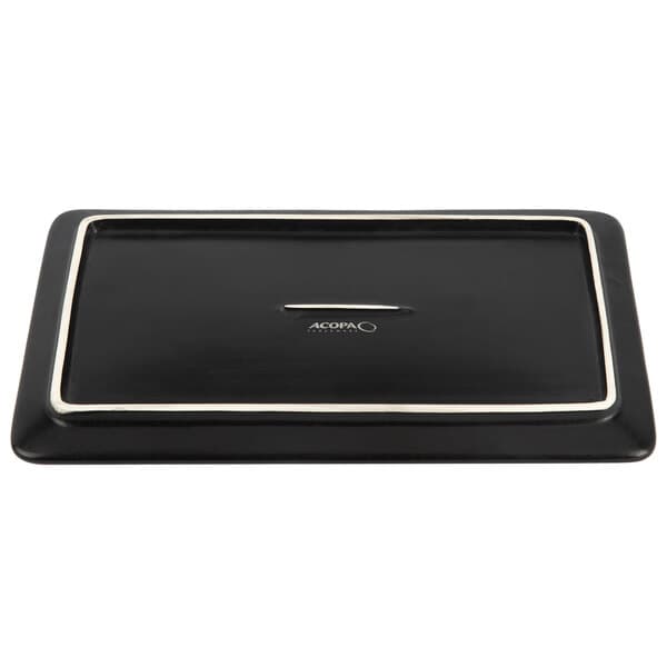 An Acopa rectangular black stoneware plate on a counter.