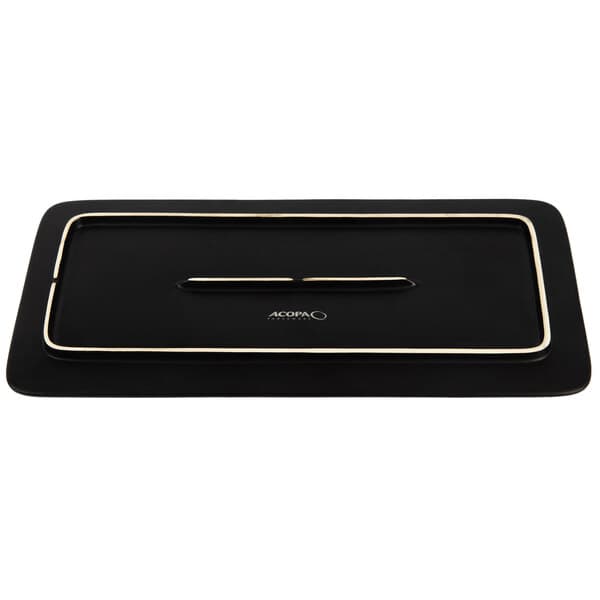 A case of six rectangular matte black stoneware plates on a table.