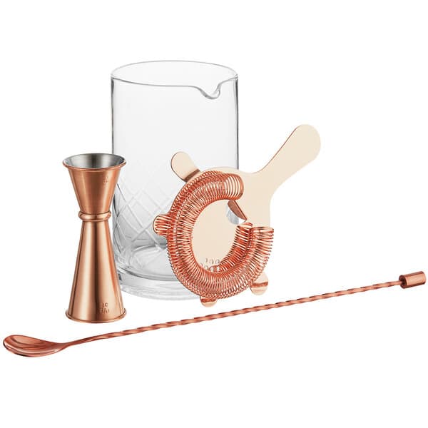 An Acopa cocktail stirring glass with a copper spoon and strainer.