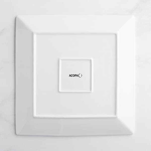 A white square Acopa porcelain plate with black text that says Kenya.