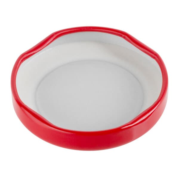 A red Acopa milk bottle lid with white accents.