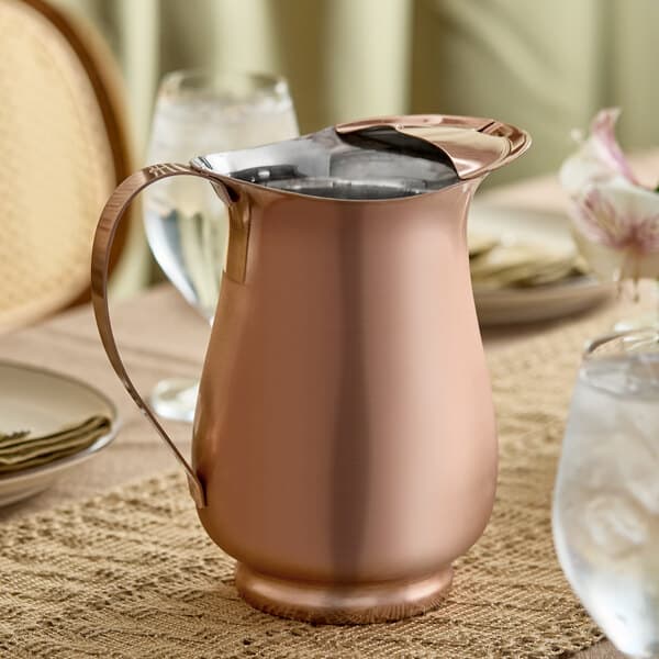 A satin copper stainless steel slender bell pitcher with an ice guard.