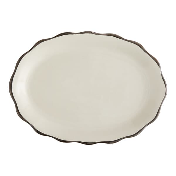 An ivory stoneware oval platter with a scalloped edge and black border.