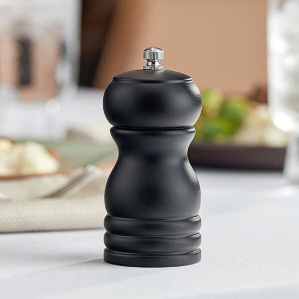 A black wooden Acopa salt and pepper mill on a table.