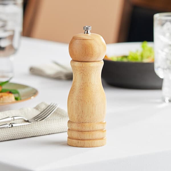 An Acopa wooden salt and pepper mill on a table.