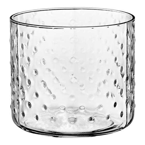 An Acopa Hobnail style double rocks glass with a clear glass container and dots.