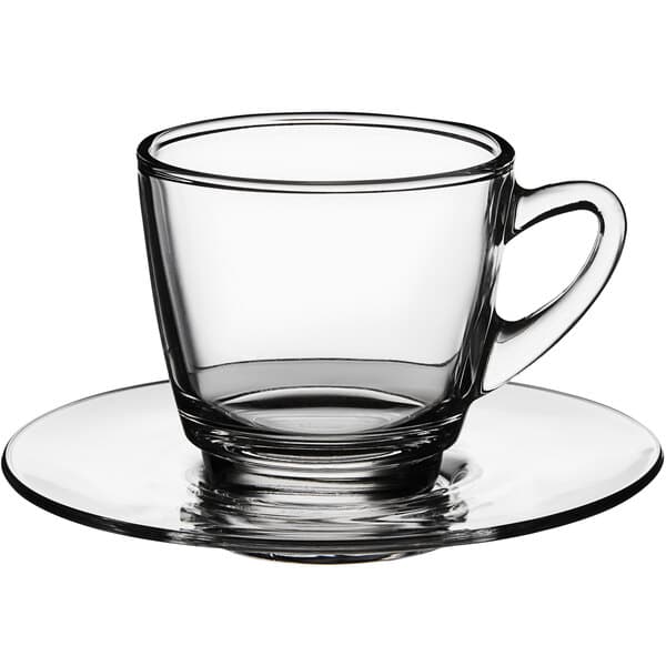 An Acopa clear glass coffee cup on a saucer.