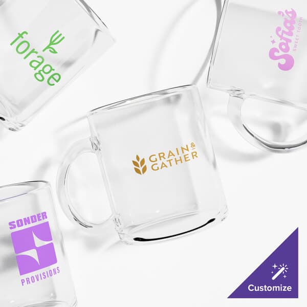 A group of Acopa clear glass coffee mugs with different logos.