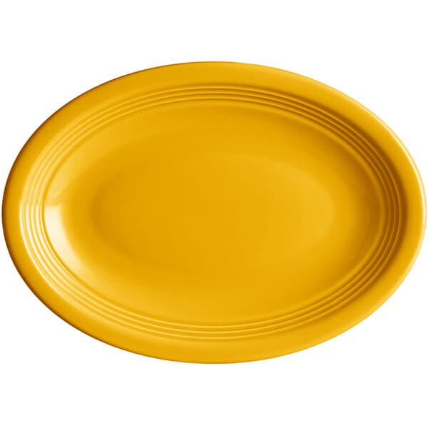 An Acopa mango orange oval stoneware platter with a rim.
