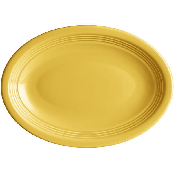 An Acopa Capri yellow oval platter with a rim on a white background.