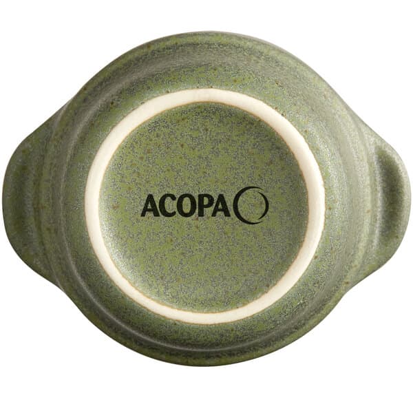 A close up of an Acopa moss green stoneware sauce cup.