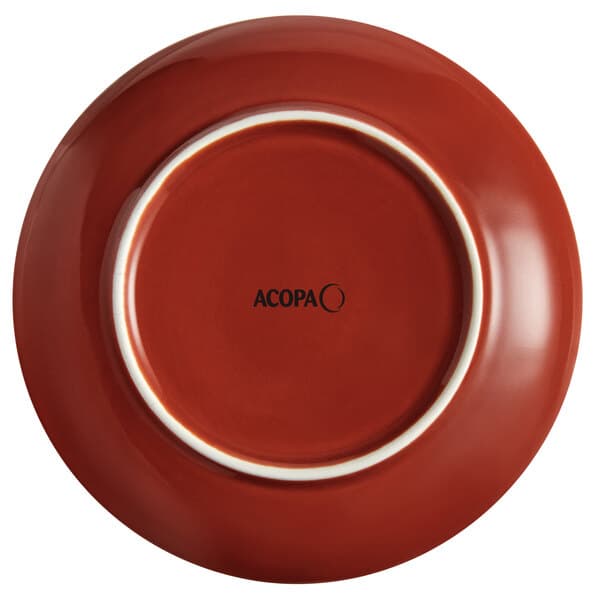 An Acopa Keystone Sedona Orange stoneware coupe plate with a white rim.