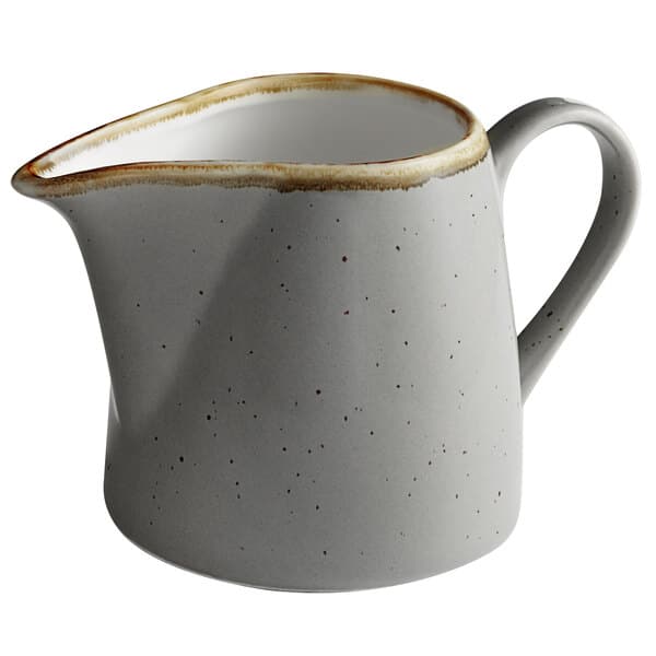 A granite gray Acopa Keystone stoneware creamer with a brown speckled rim.