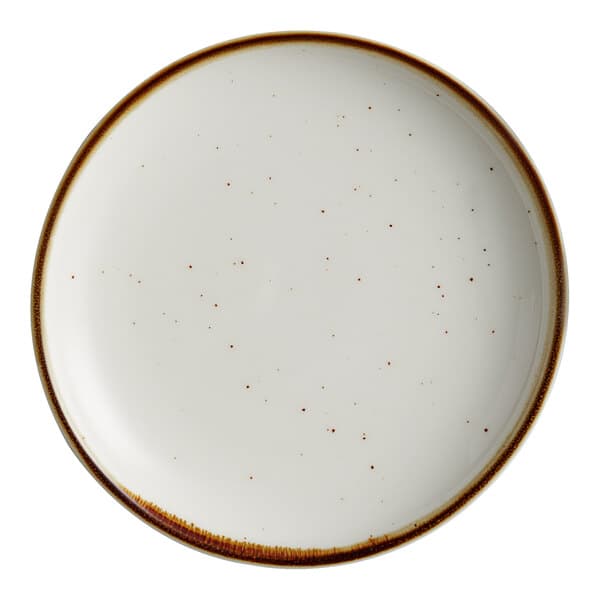 An Acopa Keystone stoneware coupe plate in vanilla bean with brown specks.