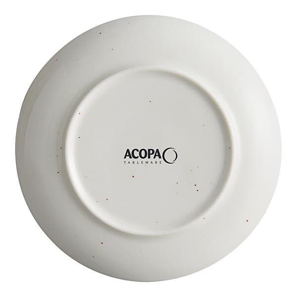 An Acopa Keystone stoneware coupe plate in white with black specks.