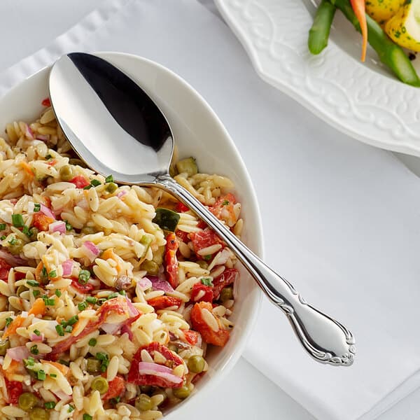 A bowl of food with an Acopa stainless steel serving spoon.
