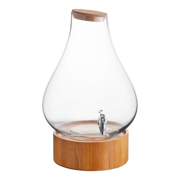 An Acopa glass beverage dispenser with a wood base and spigot.