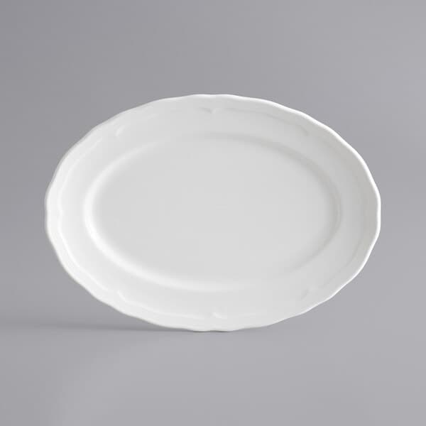 A white Acopa porcelain platter with a scalloped edge.