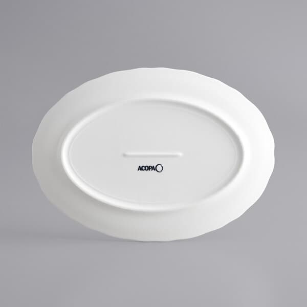 An Acopa pearl white porcelain platter with scalloped edges and a circular design on the rim.
