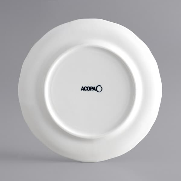 An Acopa white porcelain plate with a scalloped wide rim.