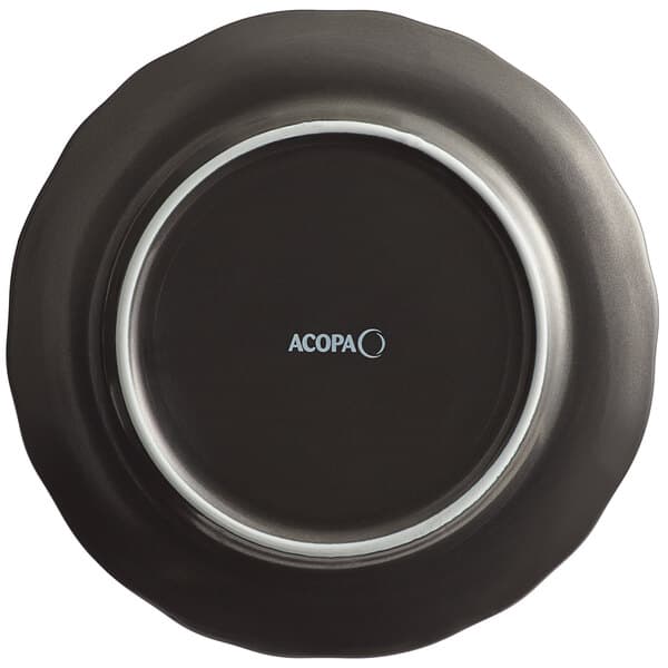 A black porcelain plate with a white scalloped border.