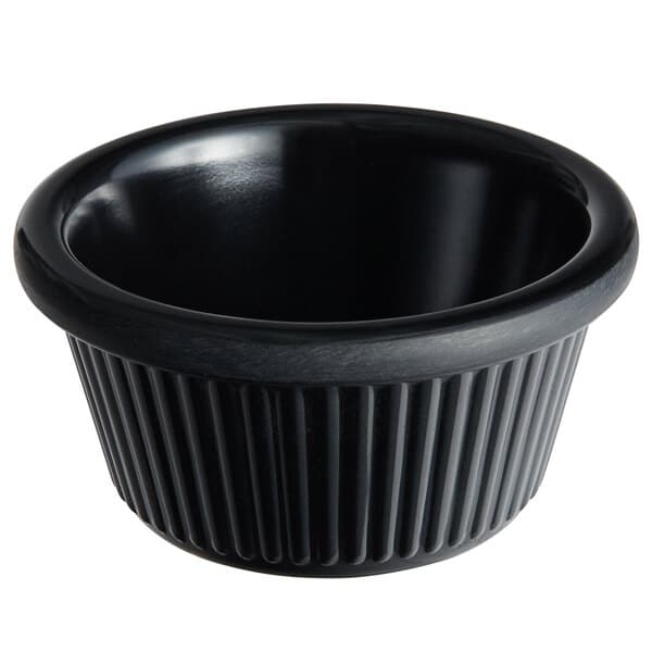 An Acopa black fluted melamine ramekin with a black rim.
