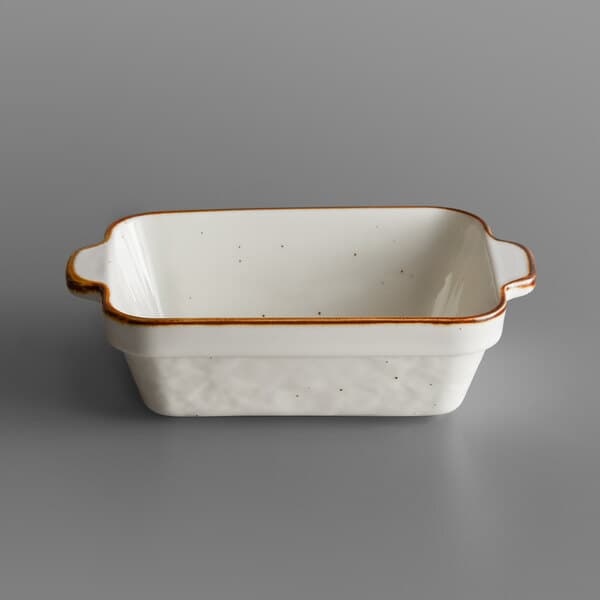 A white rectangular stoneware baker with brown specks.