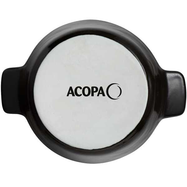 An Acopa Keystone black and white stoneware mini casserole dish with black handles.