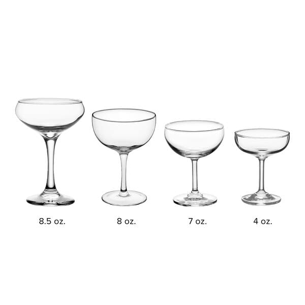A row of four clear Acopa Coupe Cocktail glasses with stems.