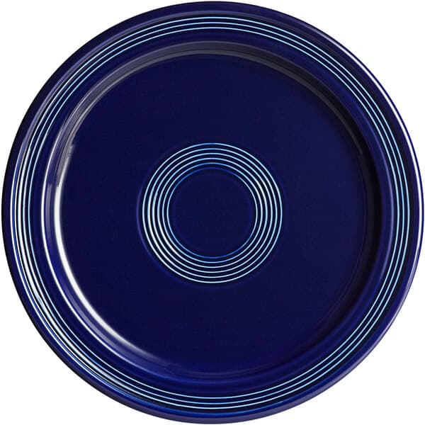 A deep sea cobalt blue plate with a spiral design in blue.