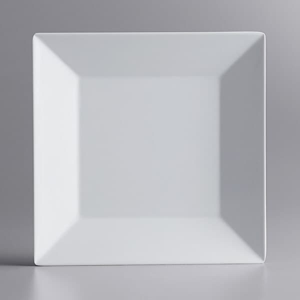 A white square Acopa Rittenhouse melamine plate on a gray surface.