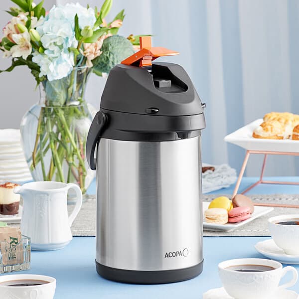 An Acopa stainless steel decaf airpot on a table.