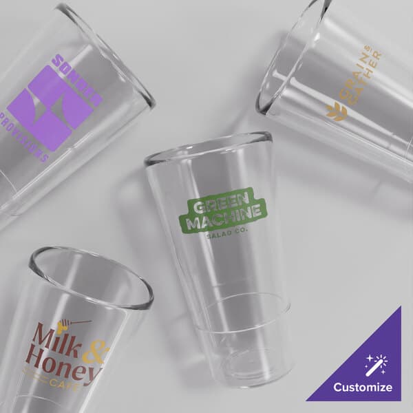 A group of clear Acopa Endure stackable plastic glasses with a purple logo.