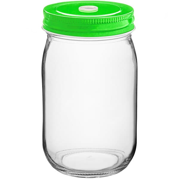A clear glass jar with a green metal lid with a straw hole.