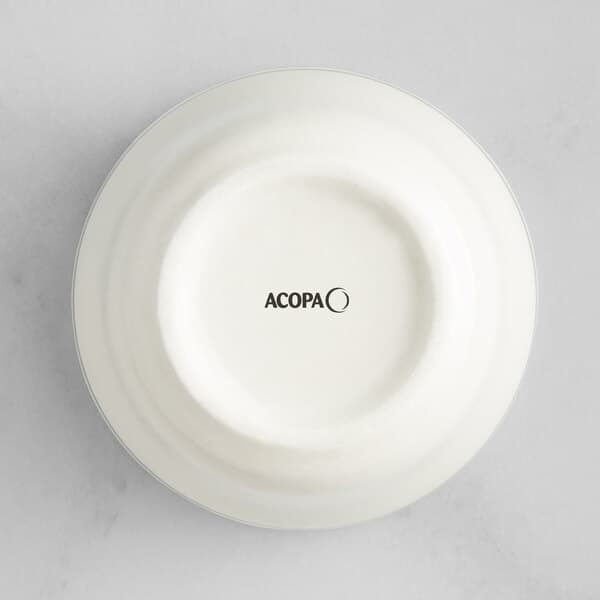 An ivory stoneware bouillon cup with green bands and the word Acopa in black.