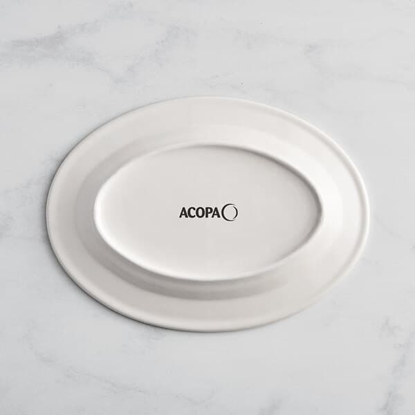 An ivory stoneware platter with green bands and a wide rim.