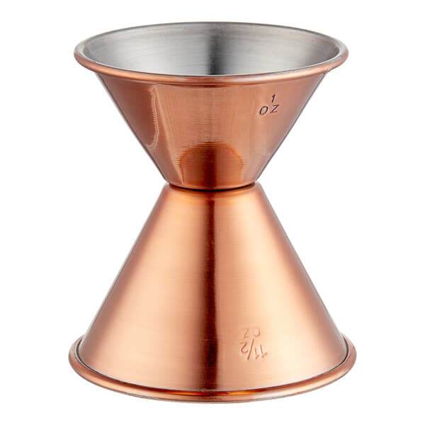 An Acopa copper measuring cup with a metal handle.