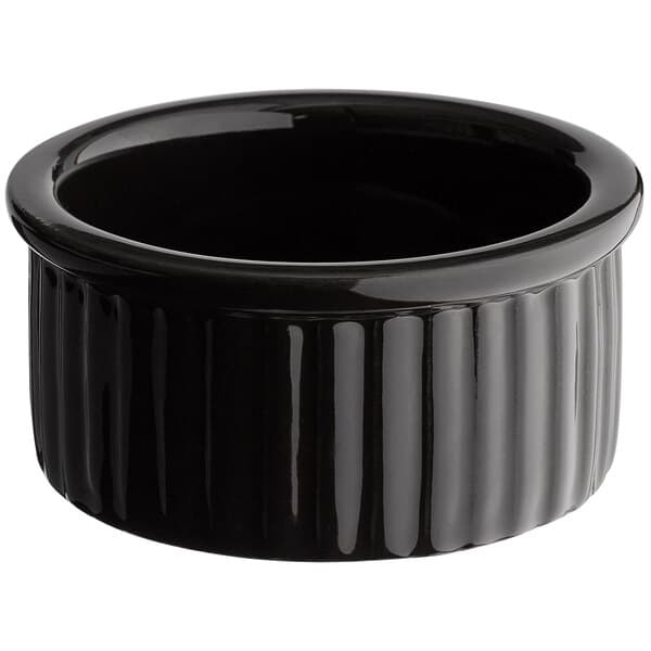 A glossy black fluted stoneware ramekin.