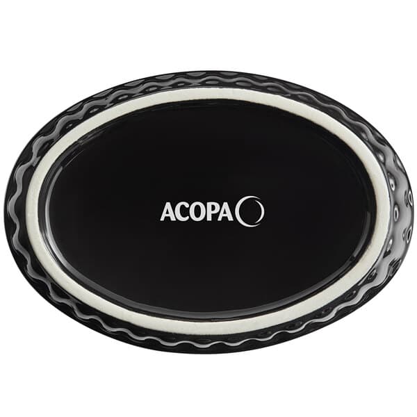 An oval black Acopa stoneware dish with fluted edges.