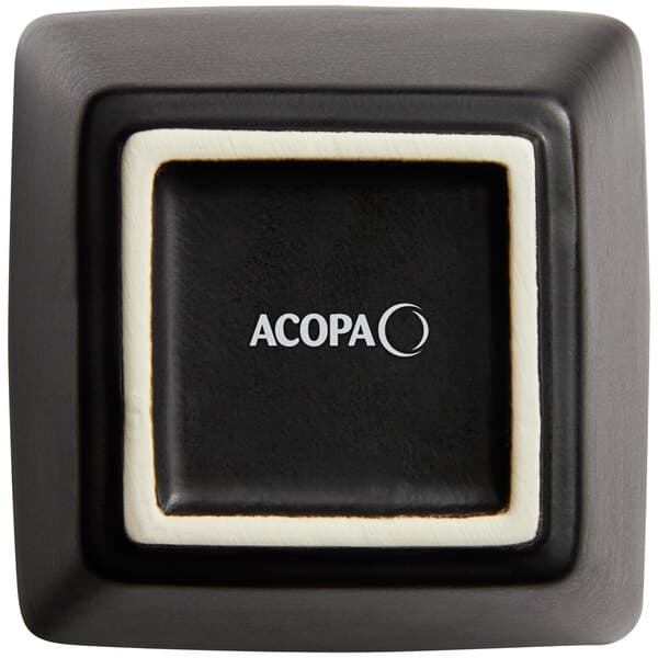 A matte black square stoneware bouillon cup with white trim.