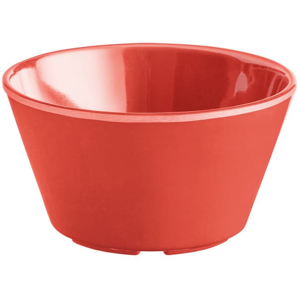 An orange melamine bowl with a white background.