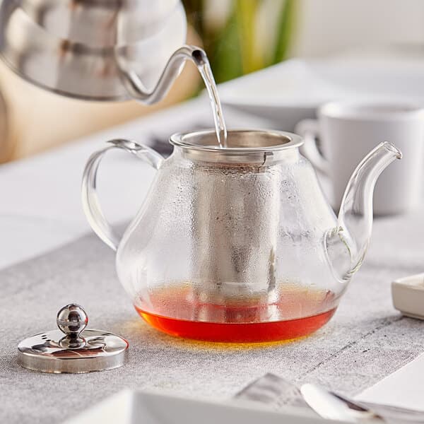 a glass teapot with liquid in it