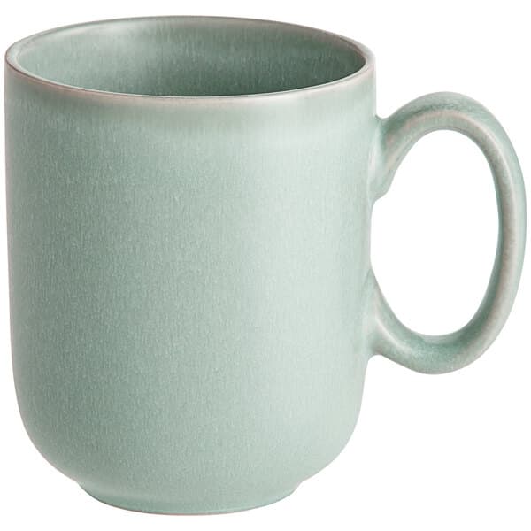 A close-up of a Harbor Blue matte porcelain mug with a handle.