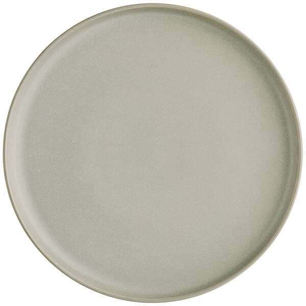 A close up of an Acopa Pangea white porcelain plate with a small rim.